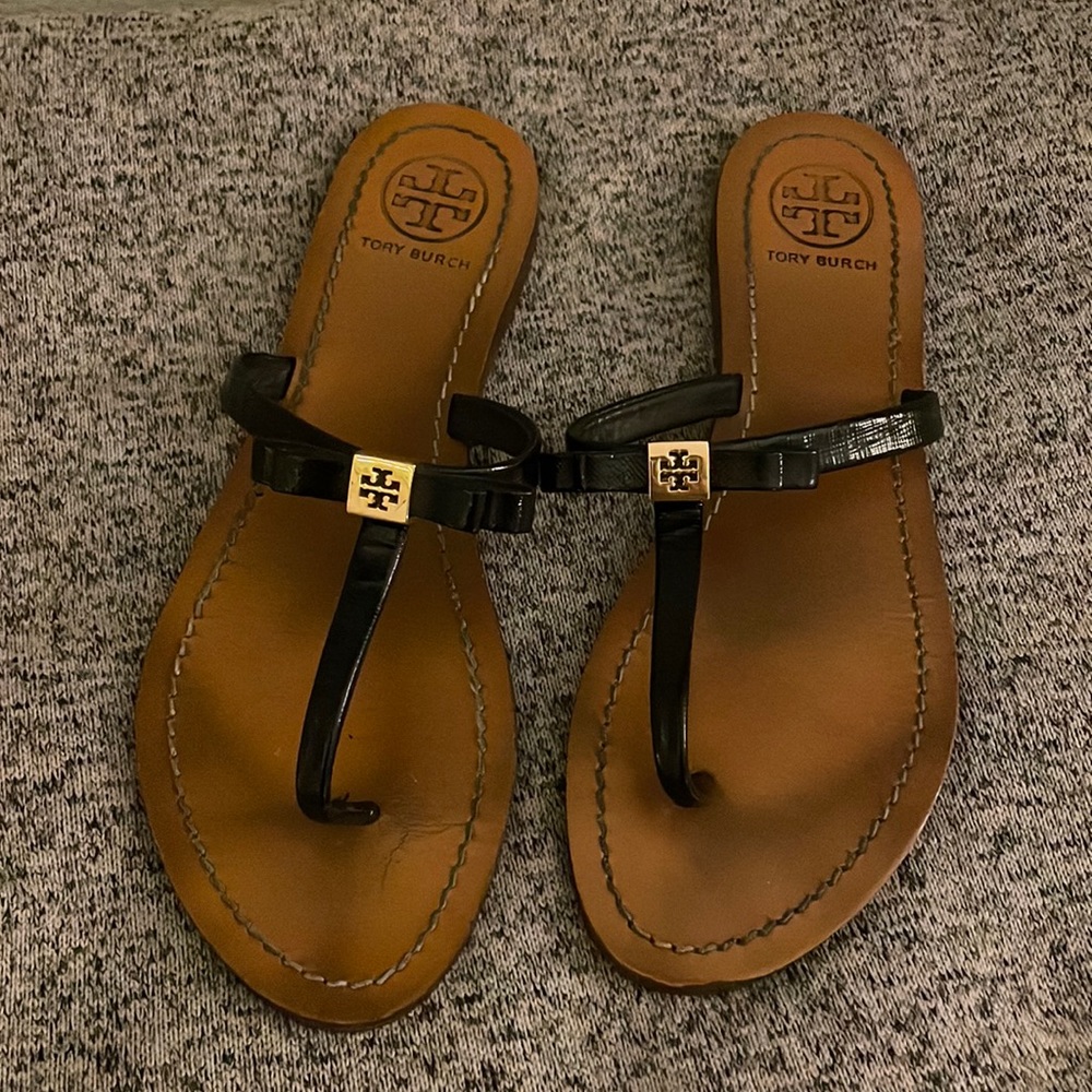 Black Tory Burch thong sandal with bow and gold detailing, size 8